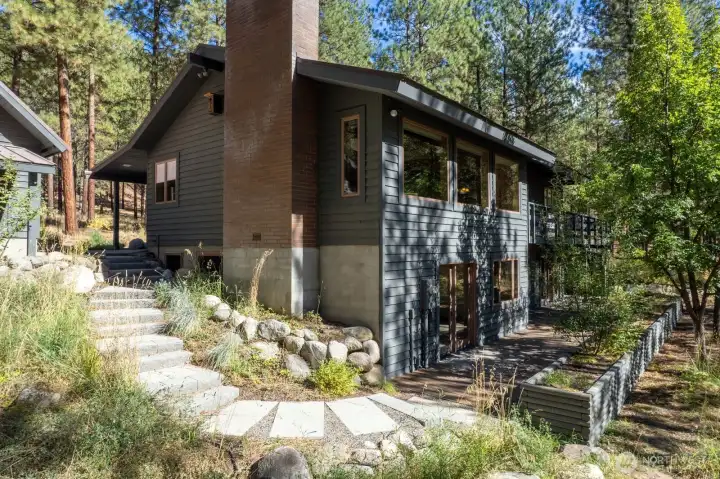 Stone steps from Garage on the SW corner of home leads to Terrace and Bonus room french doors.