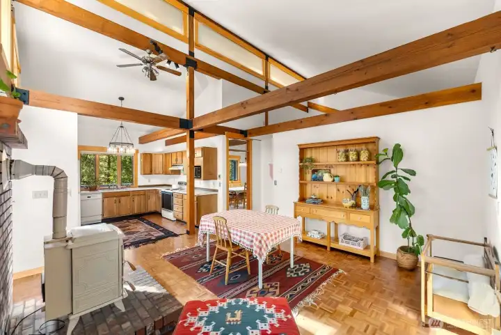 Large Kitchen offers Breakfast dining table, Reading nook, Pellet stove on brick hearth fireplace makes the Kitchen a cozy warm winter joy! Big Timber enhance the high ceilings.