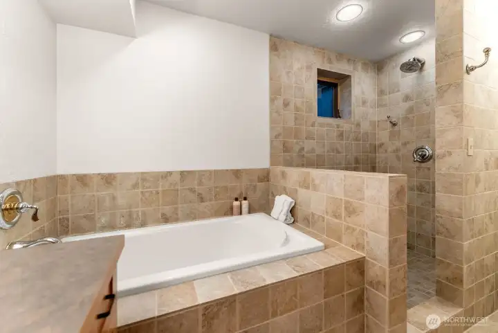 Ceramic tile Spa bath enjoys a deep soaking tub, Rain shower head for lots of water therapy at the end of a long day of adventures!