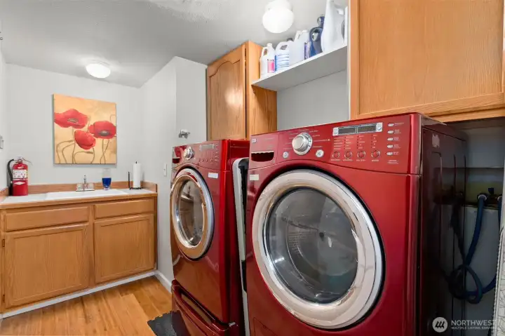 Utility/Mud room with  washer and dryer. Built in cabinets and sink.