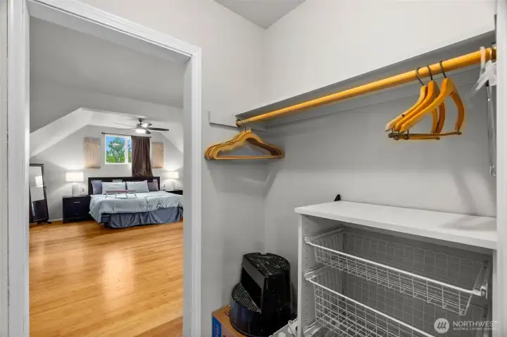 Closet in between primary bedroom and bonus room with lots of built in shelves.