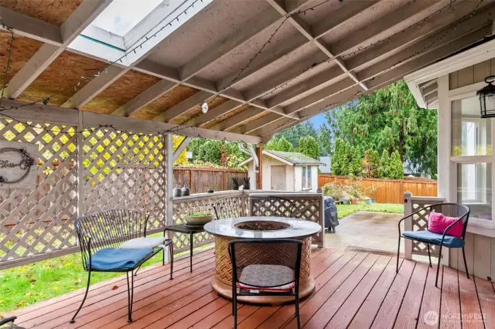 Fully covered back patio on raised deck. Skylights above for more light.