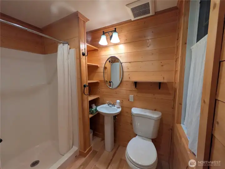The guest studio bathroom with ample storage and large window.