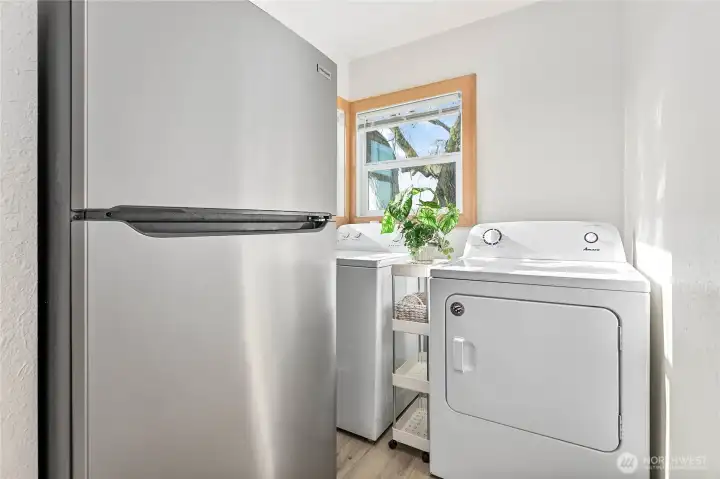 Laundry room with newer washer and dryer and a stainless steel fridge