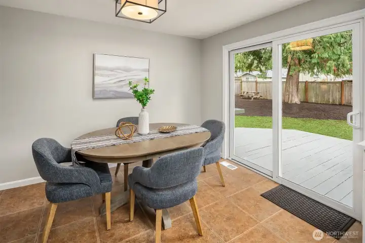 Spacious Dining Area with Sliders Overlooking Backyard