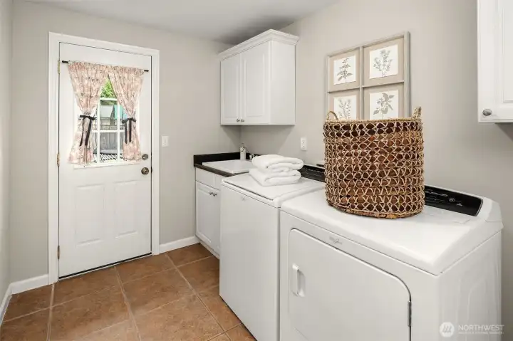 Laundry/Utility Room with Doors Leading to Backyard + Garage