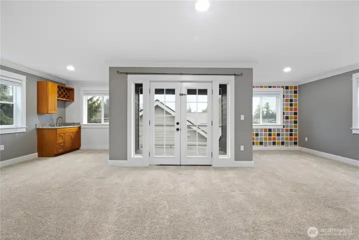 Fantastic bonus room with wet bar and French doors to the covered deck for year-round enjoyment.