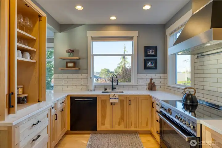The open shelving to the left has cabinet doors when not in use.  Oversize cooktop and oven for the chef!