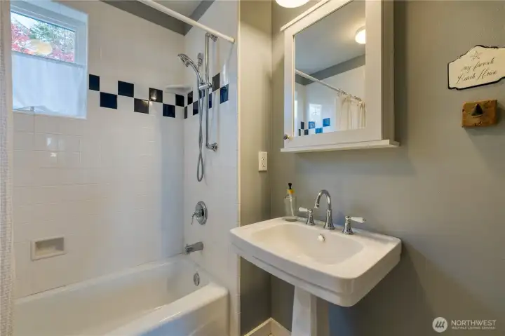 Full bath with classic pedestal sink.