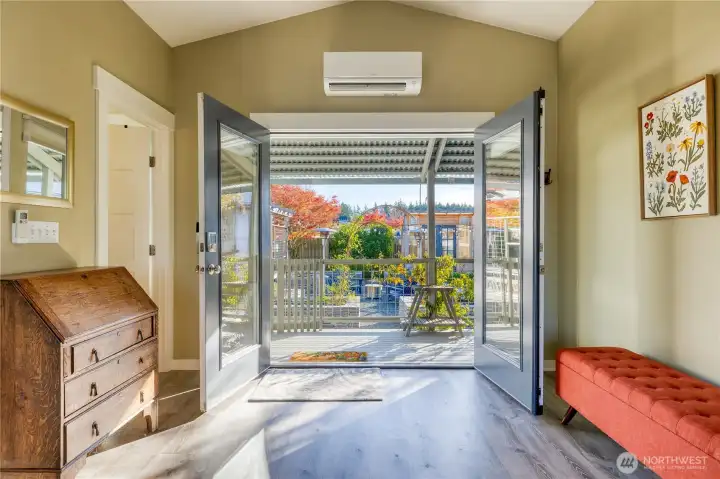 French doors at the covered entry and also to the balcony.
