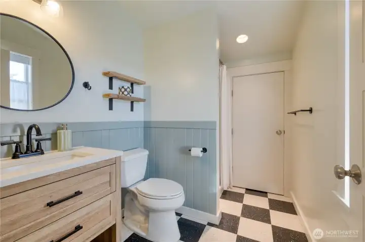3/4 Bath is well appointed with finishes, including hardware and marmoleum floor.