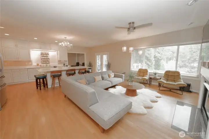 The open-concept great room connects effortlessly to the kitchen, with high ceilings and oversized windows that bring the outdoors in. The open-concept great room connects effortlessly to the kitchen, with high ceilings and oversized windows that bring the outdoors in.