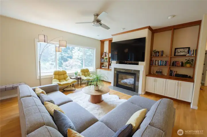 The living area offers a cozy fireplace with built-ins on either side. The living area offers a cozy fireplace with built-ins on either side.