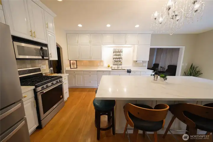 Custom white cabinetry and a charming coffee mug display add personality to this well-appointed kitchen. Custom white cabinetry and a charming coffee mug display add personality to this well-appointed kitchen.