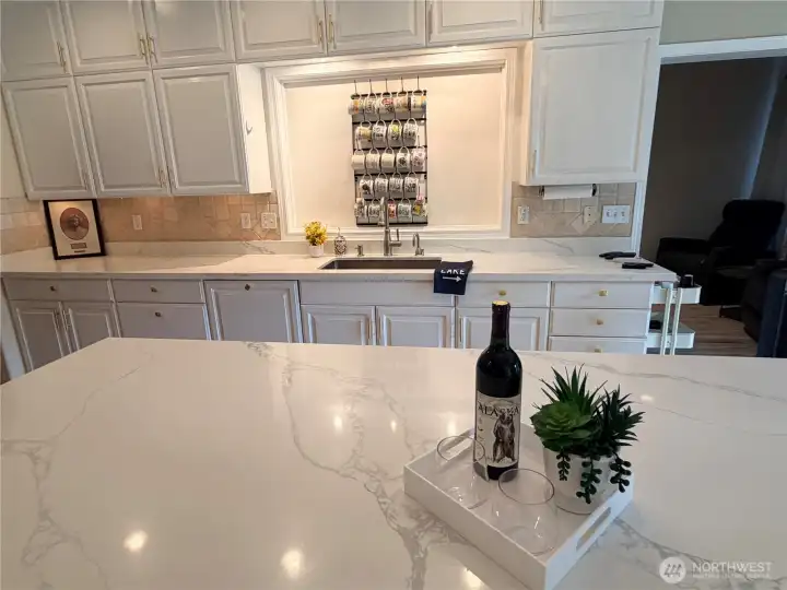 Quartz countertops and a walk-in pantry just beyond make this kitchen as functional as it is beautiful. Quartz countertops and a walk-in pantry just beyond make this kitchen as functional as it is beautiful.