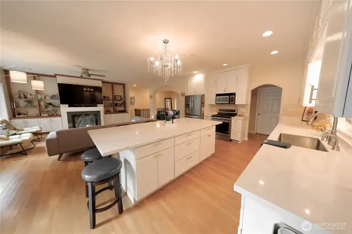 The open kitchen and great room are designed for togetherness, featuring a massive island, quartz countertops, and stainless steel appliances throughout. The open kitchen and great room are designed for togetherness, featuring a massive island, quartz countertops, and stainless steel appliances throughout.