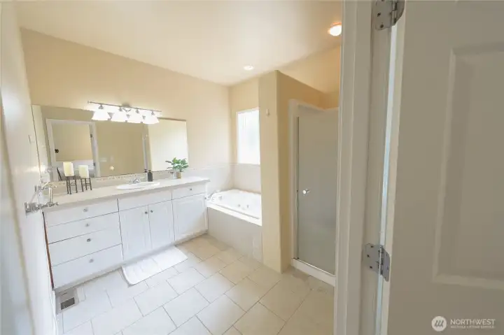 The primary bathroom feels like a retreat, with a jetted soaking tub, and a separate walk-in shower. The primary bathroom feels like a retreat, with a jetted soaking tub, and a separate walk-in shower.