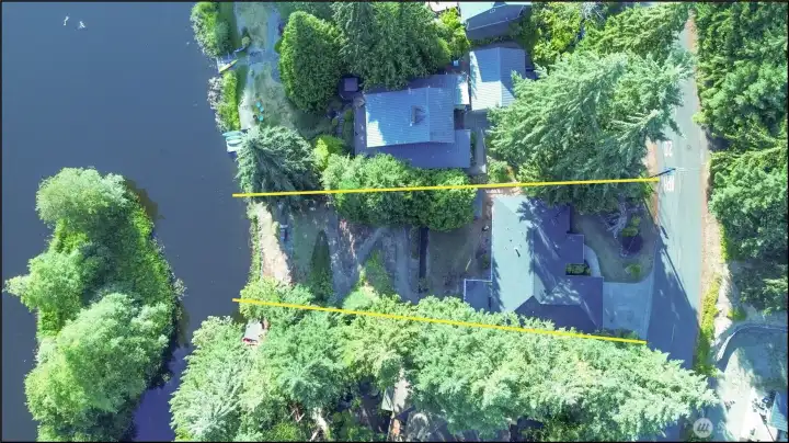 An aerial perspective highlighting the estimated property lines, giving a sense of the lot's shape and waterfront orientation. An aerial perspective highlighting the estimated property lines, giving a sense of the lot's shape and waterfront orientation.