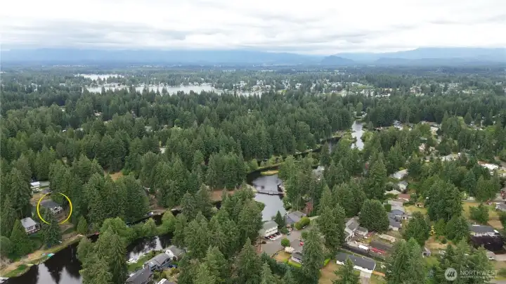 An aerial view shows just how close this home sits to both Lake Debra Jane, with the winding lake visible just beyond the trees, and Lake Tapps, sprawling in the distance. An aerial view shows just how close this home sits to both Lake Debra Jane, with the winding lake visible just beyond the trees, and Lake Tapps, sprawling in the distance.