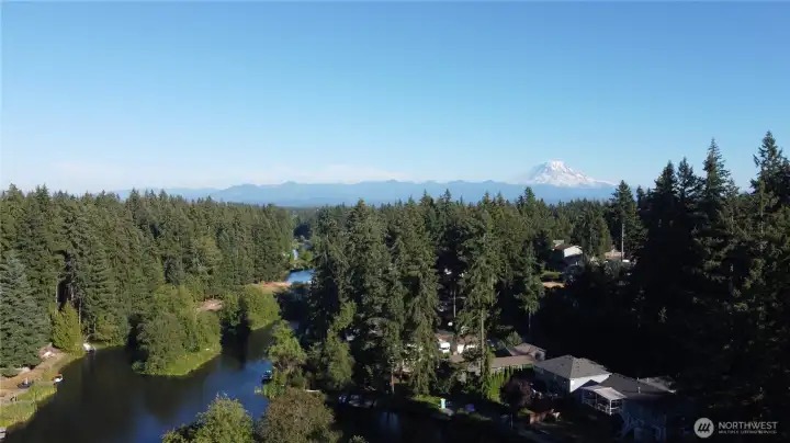 An aerial view captures Lake Debra Jane winding through the neighborhood, dotted with small islands and with Mt. Rainier rising in the distance, a daily backdrop unlike any other. An aerial view captures Lake Debra Jane winding through the neighborhood, dotted with small islands and with Mt. Rainier rising in the distance, a daily backdrop unlike any other.