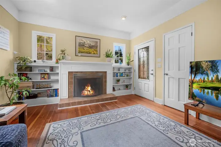 Large living room with fireplace and built in book shelves.