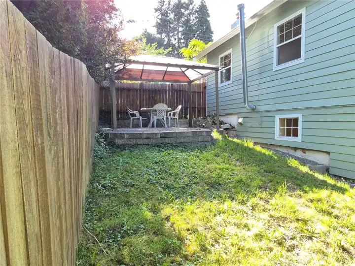 Fenced side yard covered eating area.
