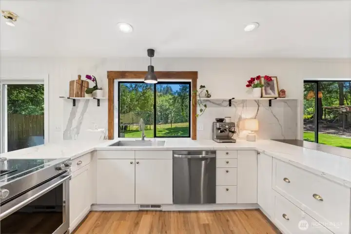 Kitchen has been updated with quartz countertops and backsplash, added cabinetry with beautiful brushed gold hardware and new stainless steel appliances Kitchen has been updated with quartz countertops and backsplash, added cabinetry with beautiful brushed gold hardware and new stainless steel appliances