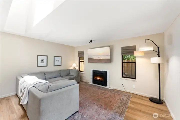 Spacious living room is highlighted by a gas fireplace and all - new white painted millwork that adds timeless style and craftmanship throughout the home. Spacious living room is highlighted by a gas fireplace and all - new white painted millwork that adds timeless style and craftmanship throughout the home.