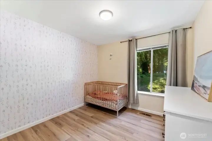 One of the three bedrooms has new LVP flooring and new painted white millwork. One of the three bedrooms has new LVP flooring and new painted white millwork.