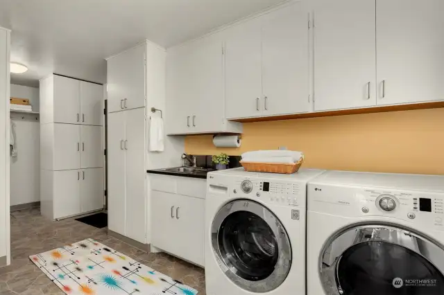 Laundry/mud room of your dreams! Storage for everything with convenient connection to the garage.