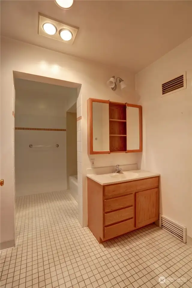 Main floor full bathroom that rivals the size of a small bedroom, offering ample space and endless possibilities! This expansive bathroom features generous square footage.