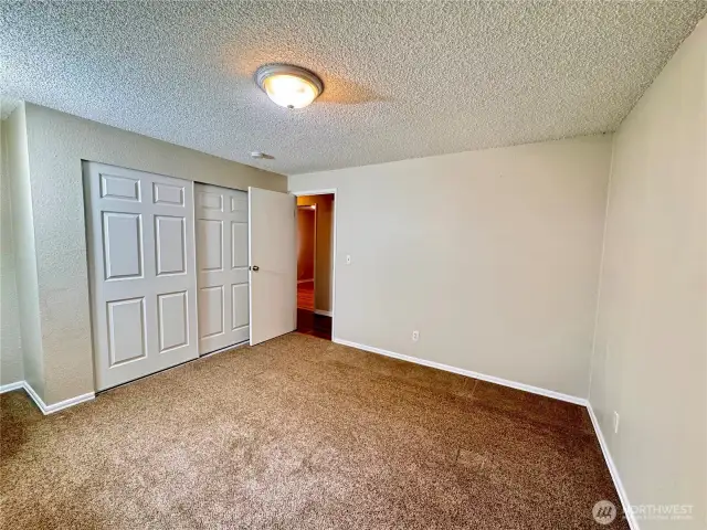 Primary bedroom with closet.