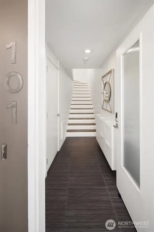Open the door to 101 and you know you’re someplace special. Each stair step is custom lit to welcome you home. Most all flooring is real hardwood.