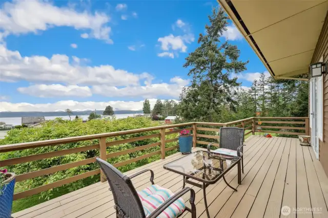 Lovely large deck with dining room and primary bedroom access.  Sit back relax and enjoy the views of Saratoga Passage and the Olympic Mountains.