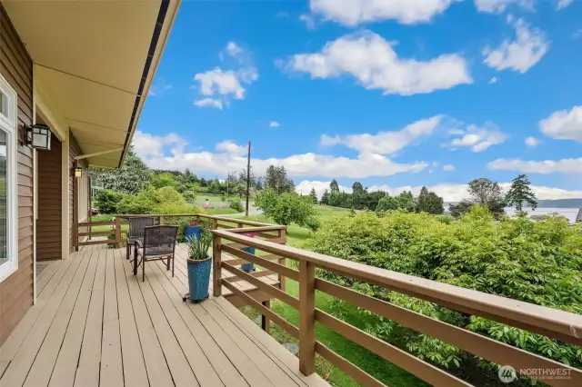 Lovely large deck with dining room and primary bedroom access.  Sit back relax and enjoy the views of Saratoga Passage and the Olympic Mountains.