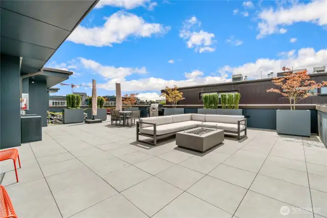 The well-appointed rooftop deck includes a seating area with fire feature, dining table, BBQ and views!