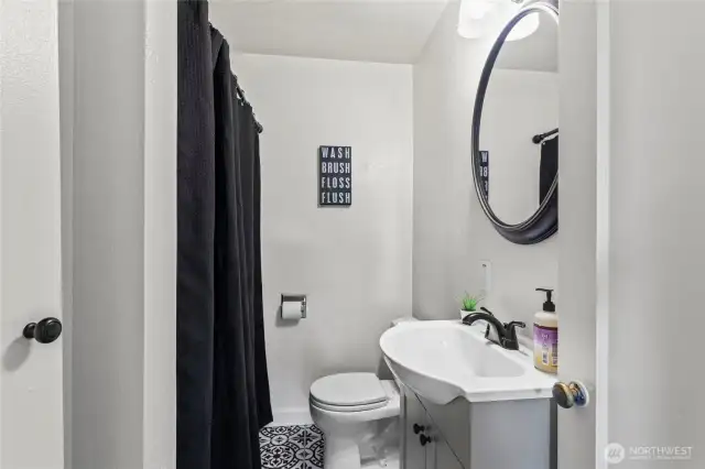 Full bathroom in hallway between primary and other bedroom.