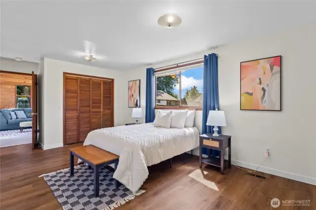 Primary bedroom with two closets and access to the primary bathroom and bonus space.