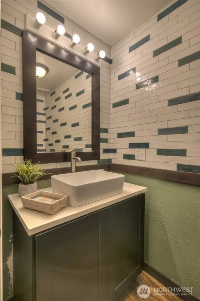 Downstairs half bath with custom tiled walls