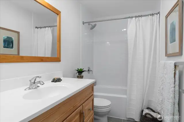 Updated main floor full bath is conveniently located adjacent to main floor bedrooms