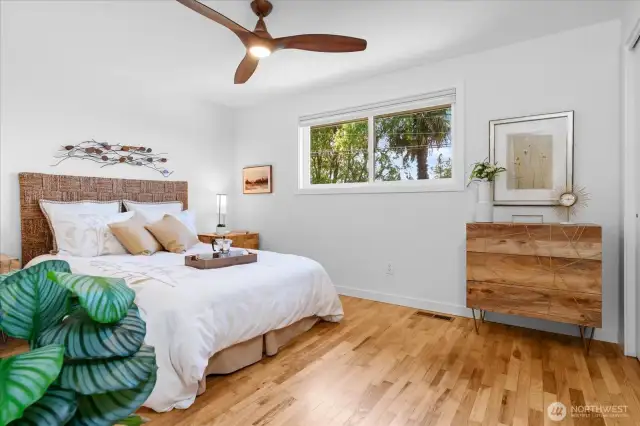 Primary bedroom offers birds-eye neighborhood views and stunning hardwood floors
