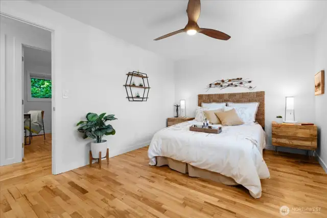 A lighted ceiling fan in primary bedroom creates additional air flow on warmer days
