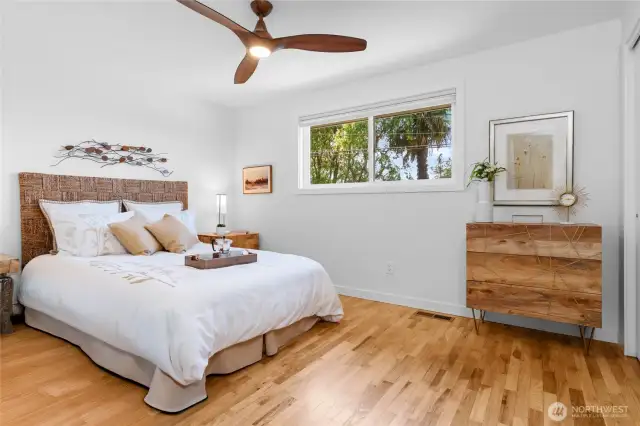 Primary bedroom offers birds-eye neighborhood views and stunning hardwood floors