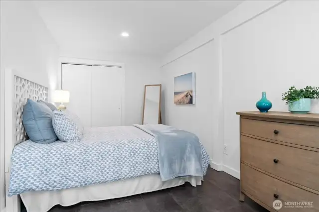 Secondary bedroom on lower level accommodates a queen-sized bed and  offers a private entrance