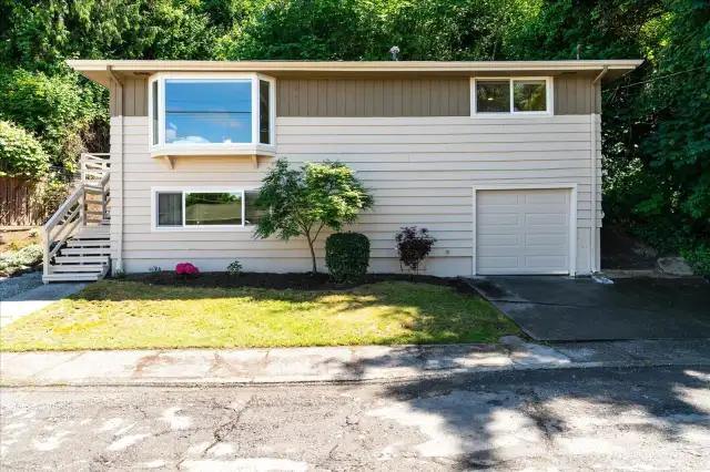Newer vinyl windows and new garage door add to the overall home aesthetics