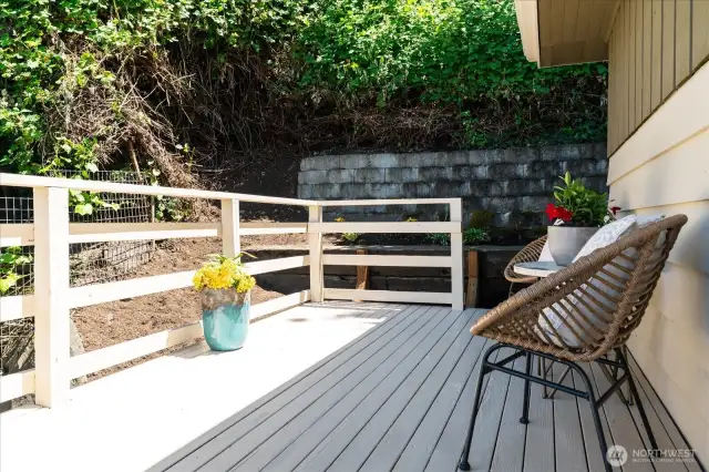 Low maintenance back yard offers privacy and planting areas for shrubs and plants