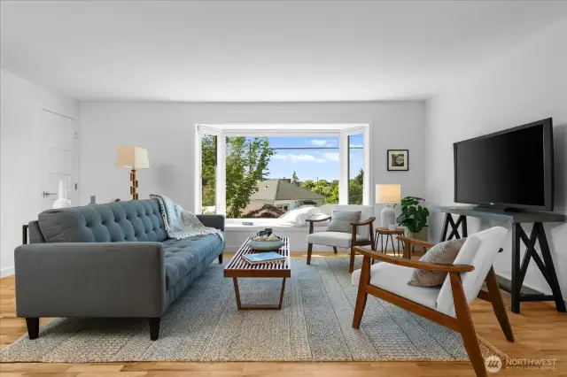 Spacious great room with bay window is illuminated with natural light