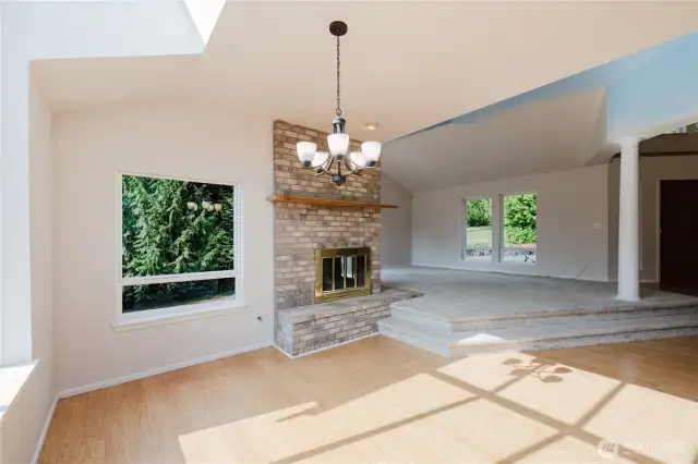 View from your dining room towards your vaulted ceiling living room with all the natural lighting.