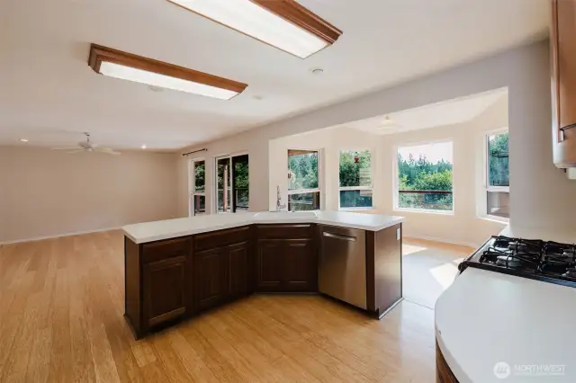 As you step into the kitchen, your senses are immediately greeted by an airy openness that seamlessly flows toward the living room. The expansive windows invite an abundance of natural light, casting a warm, inviting glow across the space.