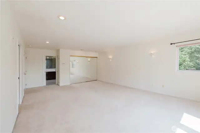 Primary bedroom with Walk-in closet to the left sliding mirrored closet to the right and primary 5 pc bathroom.
